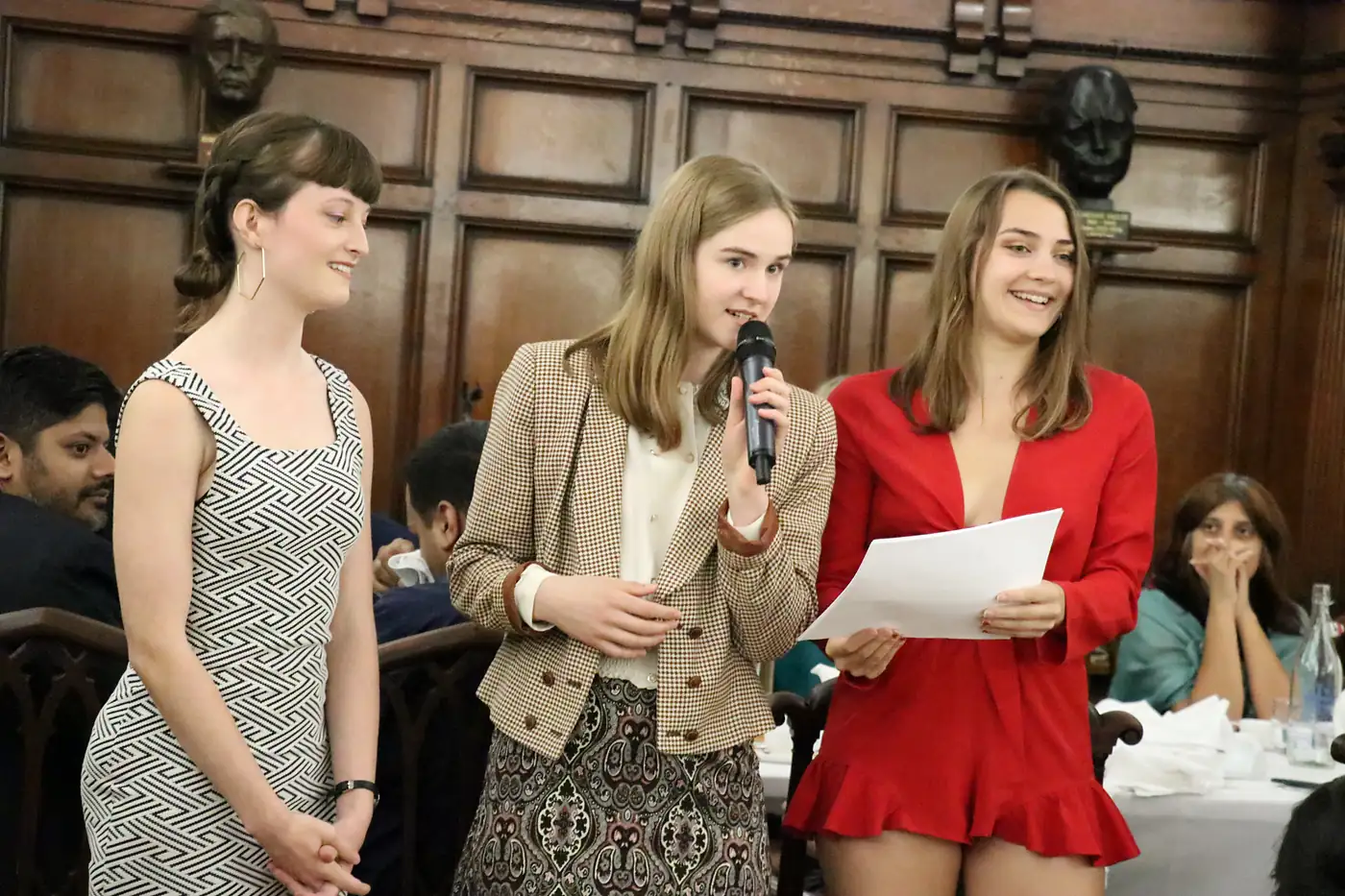 Students making their case in a panelled debating hall