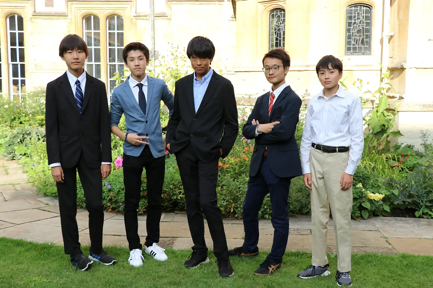 Participants in formal dress in a college garden